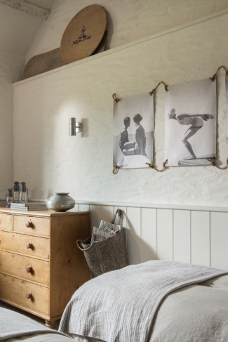 Vintage artwork peppers the walls of the twin bedroom