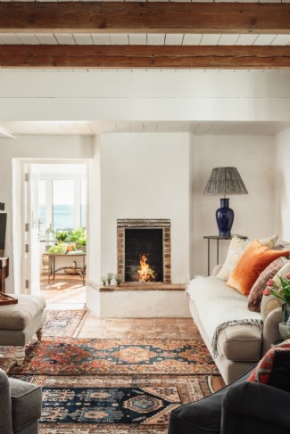 The open fireplace pictured is now one of three woodburners throughout