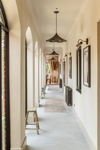 The long corridor is bright and airy thanks to multiple arched windows