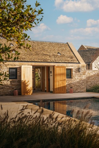 The tranquil pool, enclosed in Cotswold stone, invites endless days of summer