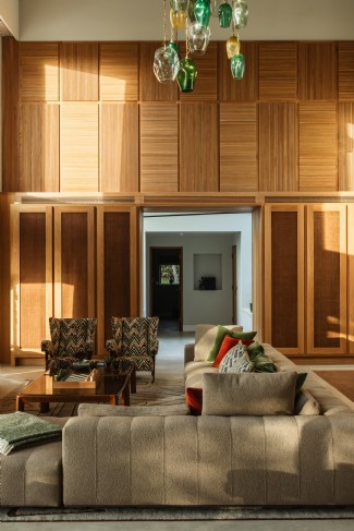 The living room has soaring, triple-height ceilings