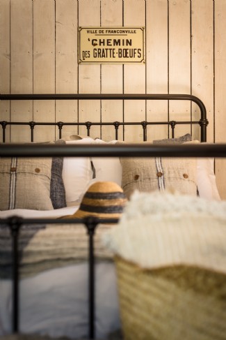 Minimalist master bedroom with rustic wrought iron bed