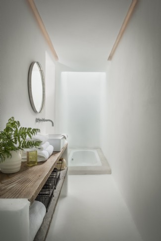 The stunning light-filled bathroom with a glass roof and sunken bath