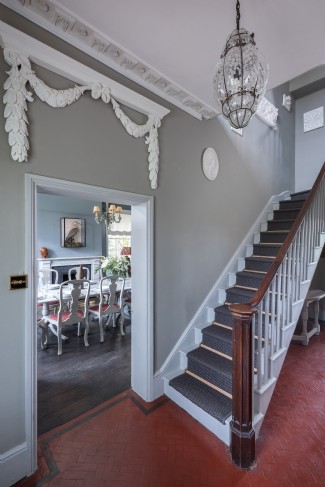 The original Georgian staircase sweeps up to five sumptuous bedrooms