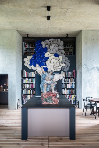 Blue cloth art helps give the cavernous kitchen a modern edge