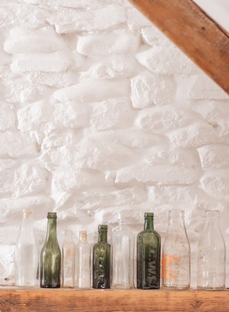 Found treasures adorn the interior, including colorful glass bottles