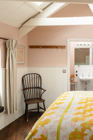 The principle bedroom is bathed in soft light and is decorated with restful hues